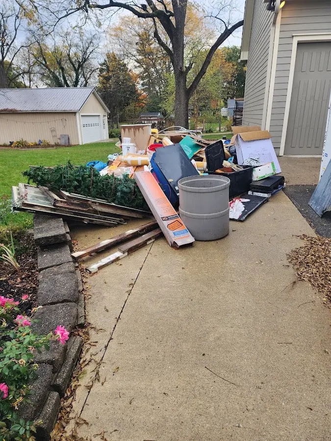 Dumpster being loaded with debris for Estate Cleanout Dumpster Rental in Middleton